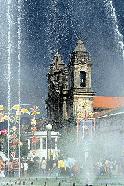 One of the many churches of Braga through a veil of water from a fountain on the main plaza